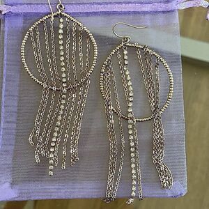 Golden dangle earrings with rhinestone fringe accents